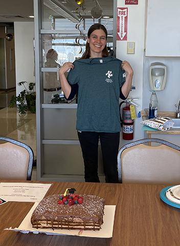 Postdoctoral Student receives her DCM T-shirt.