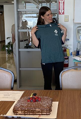 Postdoctoral Student receives her DCM T-shirt.